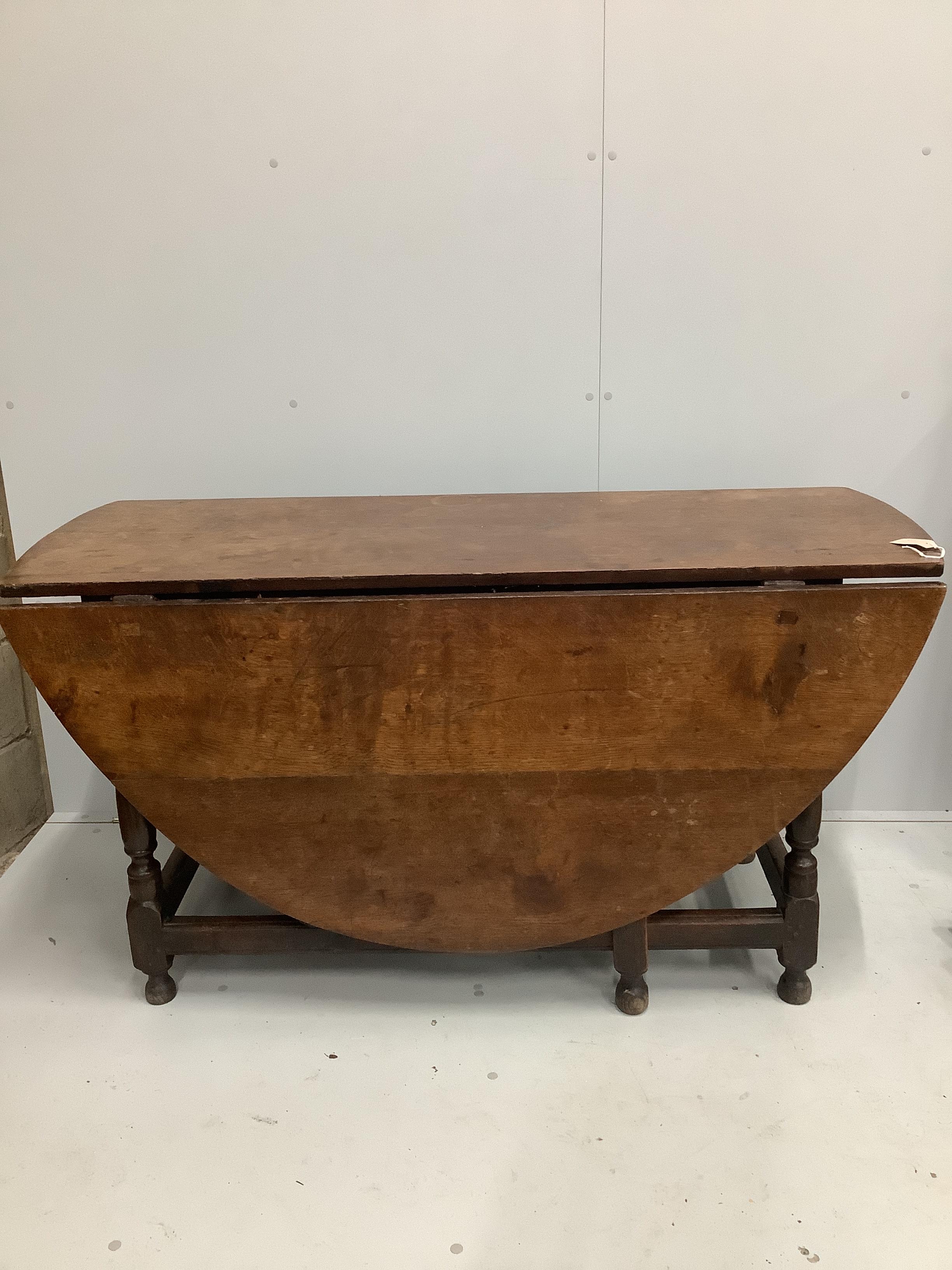 An 18th century and later oval oak gateleg dining table, length 173cm extended, depth 140cm, height 75cm